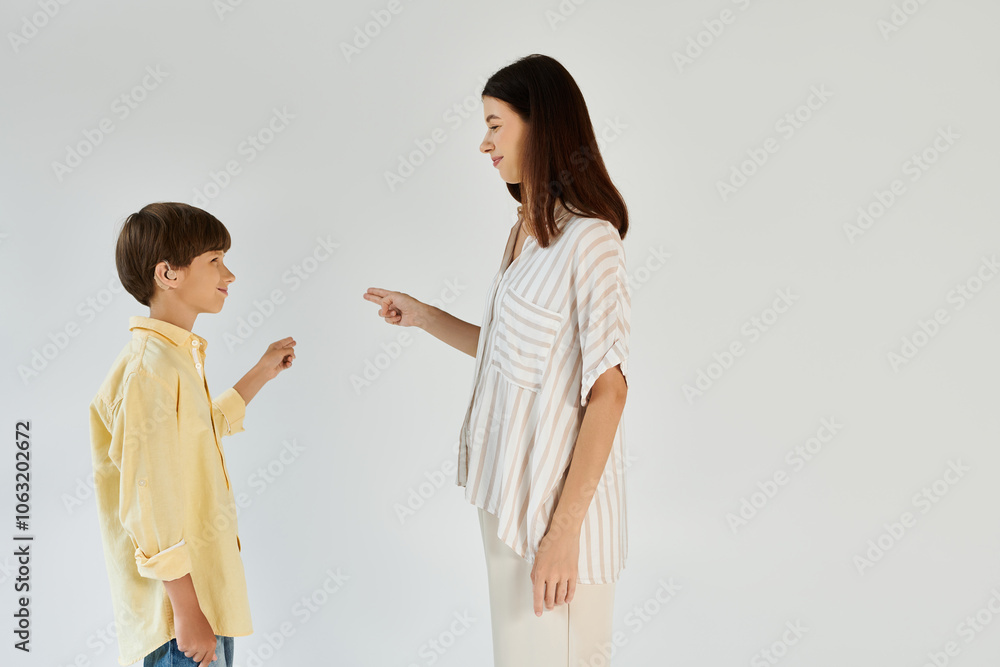 A mother interacts with her son, demonstrating communication techniques for his hearing impairment. A mother interacts with her son, demonstrating communication techniques for his hearing impairment.