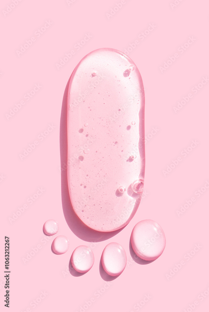 round drops of transparent gel serum on pink background round drops of transparent gel serum on pink background
