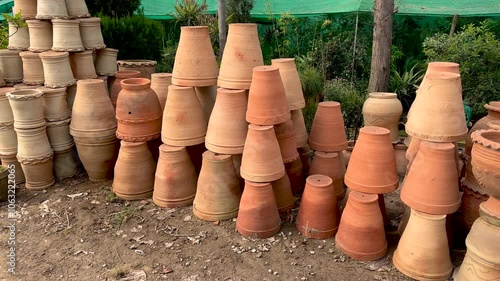 New empty handmade clay flowerpots for plants in shop for sale