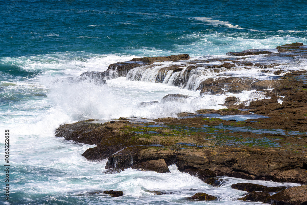 Waves crashing on a rock ledge Waves crashing on a rock ledge
