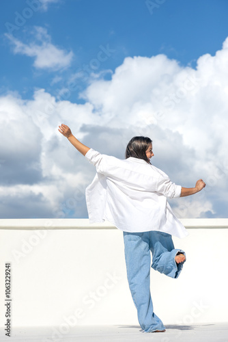 Joyful pregnant woman on the background of the sky. Concept of pregnancy.