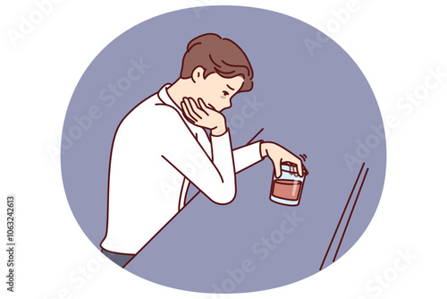 Man drinks alcohol sitting alone in bar and suffers from depression after divorce or being fired from job. Sad guy with glass of whiskey experiences alcohol addiction due to failures in personal life