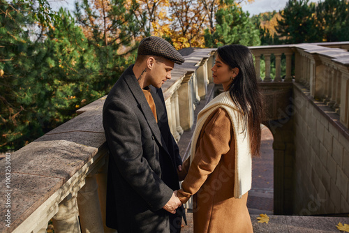 A couple shares a warm connection on a beautiful autumn day in nature. photo