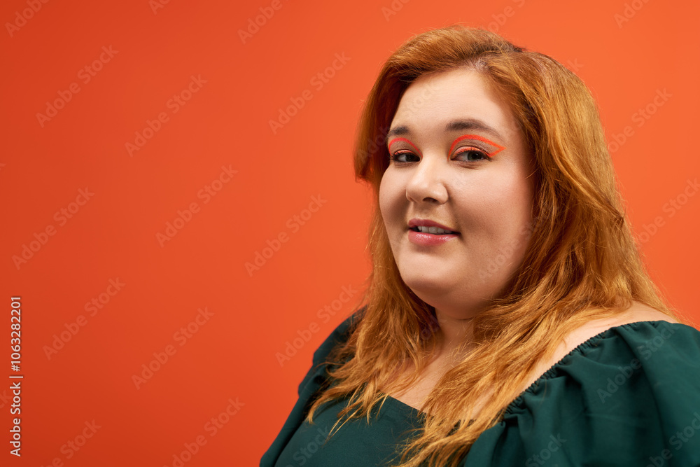 A stylish plus size woman showcases her confidence with creative makeup against a bold background. A stylish plus size woman showcases her confidence with creative makeup against a bold background.