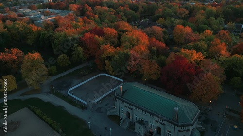 aerial shot tilting up revealing Montreal city skyline at sunset during fall season from Lafontaine Park, Quebec province, Canada photo