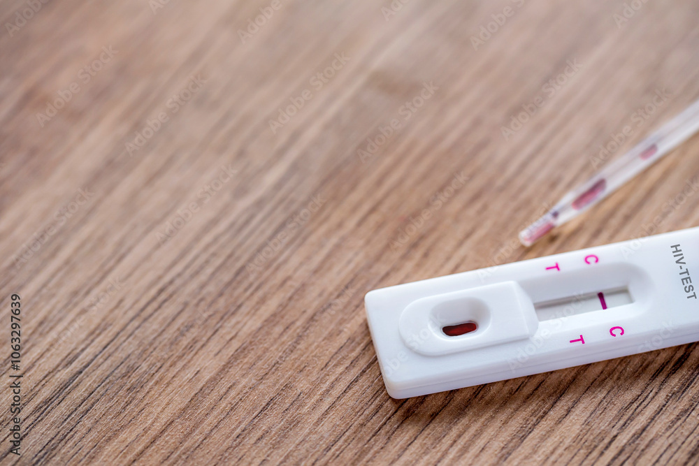 Close up of HIV self-testing kit with Negative test on wooden table. Close up of HIV self-testing kit with Negative test on wooden table.