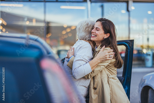 Fotografie Joyful Reunion Between Young Woman And Elderly Lady Embracing Outdoors