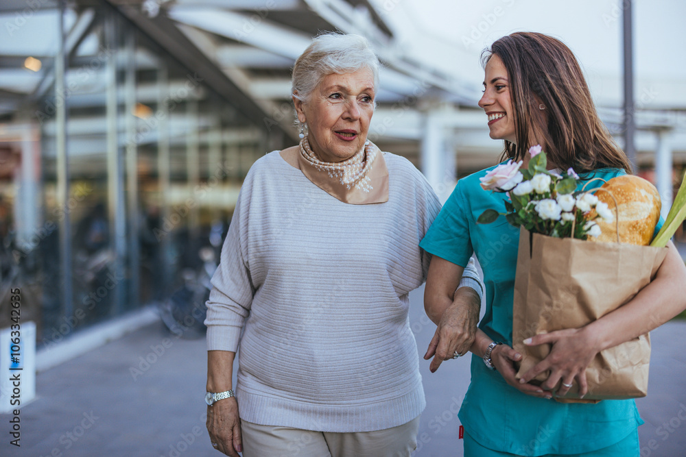 Caring Nurse Assisting Elderly Woman With Groceries Outdoors Caring Nurse Assisting Elderly Woman With Groceries Outdoors