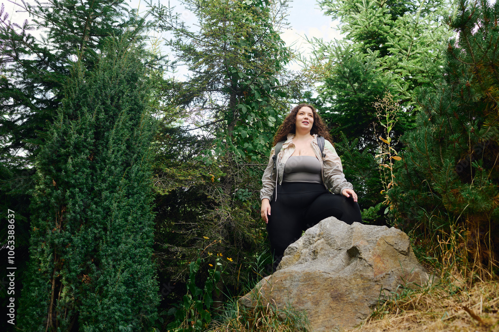 A vibrant plus size woman explores a scenic forest, surrounded by lush greenery and natures beauty. A vibrant plus size woman explores a scenic forest, surrounded by lush greenery and natures beauty.