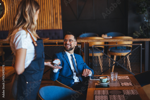 Φωτογραφία Businessman Smiling While Talking to Waitress in Modern Café