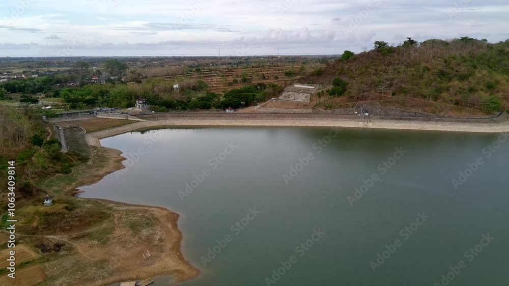 Aerial view of the natural lake between islands and hills. This lake is an artificial lake which is usually called a water dam for irrigating rice fields during the dry season. Aerial view of the natural lake between islands and hills. This lake is an artificial lake which is usually called a water dam for irrigating rice fields during the dry season.