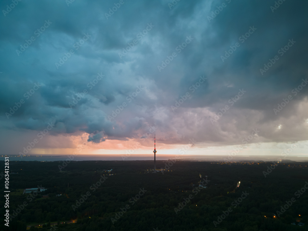 Tallinn TV tower during a storm, sky with clouds, photo view from a drone. Tallinn TV tower during a storm, sky with clouds, photo view from a drone.
