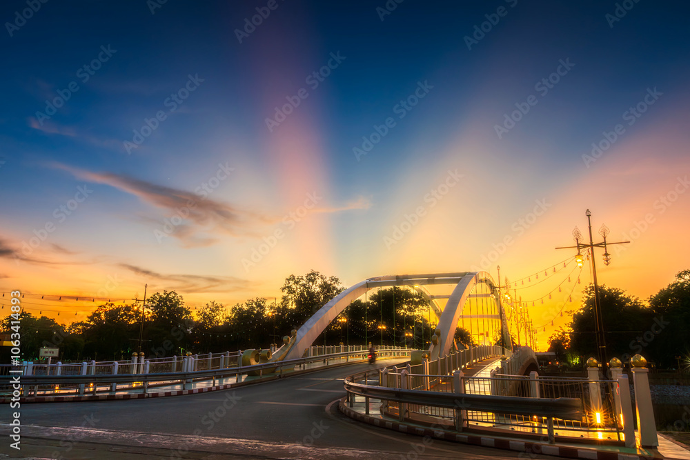 Obraz premium light Bridge over the Nan River (Wat Phra Si Rattana Mahathat also - Chan Palace) New Landmark It is a major tourist is Public places attraction Phitsanulok,Thailand.vivid Twilight dramatic sunset.