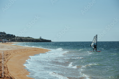 Canvas Print A man is surfing on a board in the ocean