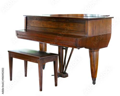 Photos A traditional spinet piano crafted from wood, accompanied by a matching bench