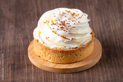 Lemon tartlets with whipped cream, sprinkles and chocolate chips on white background