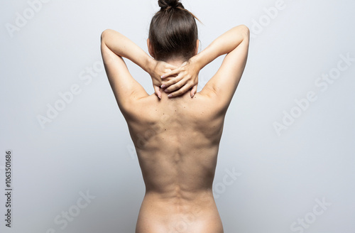 Back view of a woman with great skin. Pain, skin care. Isolated on white background.