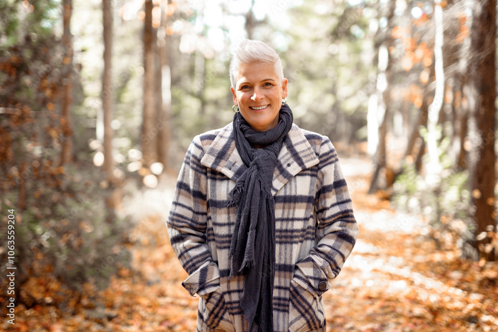 Mature woman in autumn forest, dressed in cozy fall attire, Reflection and connection with nature, wellness Mature woman in autumn forest, dressed in cozy fall attire, Reflection and connection with nature, wellness