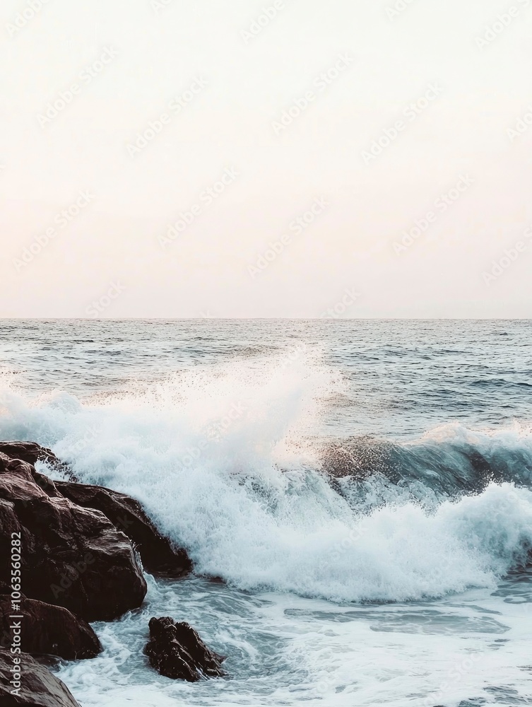 Fototapeta premium Gentle ocean waves crashing on a rocky shore at sunset, soft pastel tones and long exposure effect