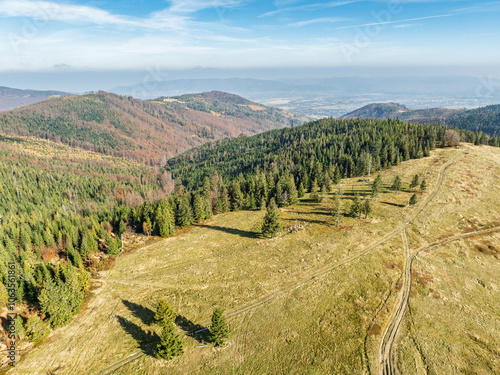 Beautiful sunny autumn in the Silesian Beskid.Aerial drone view of beskid mountains in autumn.Colorful autumn trees and forest in the mountains. Glinne, Radziechowska, Barania in the Polish Beskids. photo