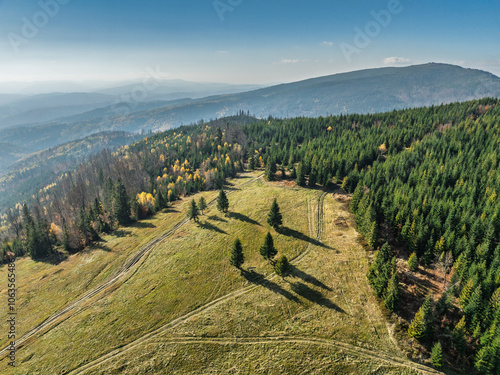 Beautiful sunny autumn in the Silesian Beskid.Aerial drone view of beskid mountains in autumn.Colorful autumn trees and forest in the mountains. Glinne, Radziechowska, Barania in the Polish Beskids. photo