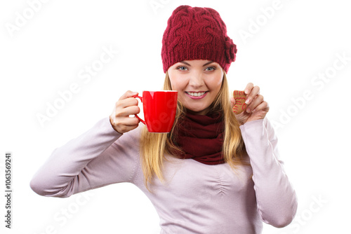 Woman in cap and shawl holding gingerbread and cup of hot tea, christmas time