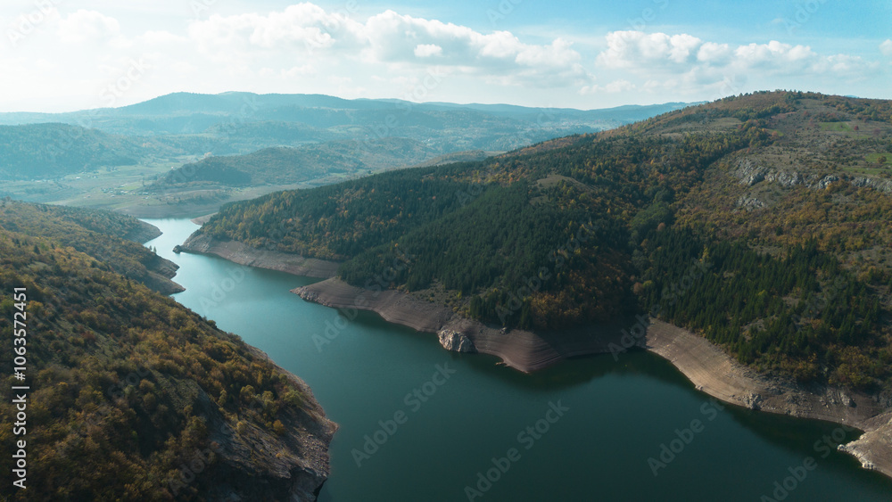 Aerial drone view of the canyon of the river Uvac in southwestern Serbia. A winding river with clear blue water on sunny autumn day. A popular place for tourists to visit. Aerial drone view of the canyon of the river Uvac in southwestern Serbia. A winding river with clear blue water on sunny autumn day. A popular place for tourists to visit.