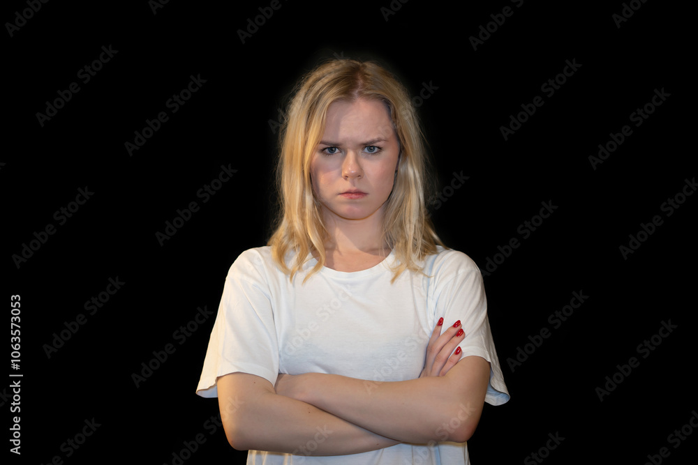 Serious young woman with crossed arms expressing determination Serious young woman with crossed arms expressing determination