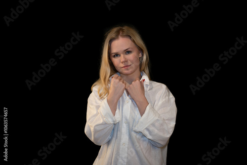 Portrait of a young woman in a white shirt against a dark background