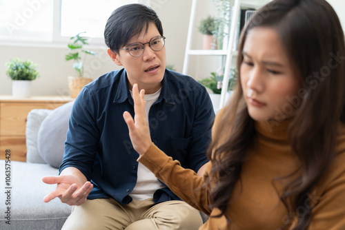 Family problem concept, Asian wife and husband sitting back to back in the living room at home have problems in a relationship and have an argument photo