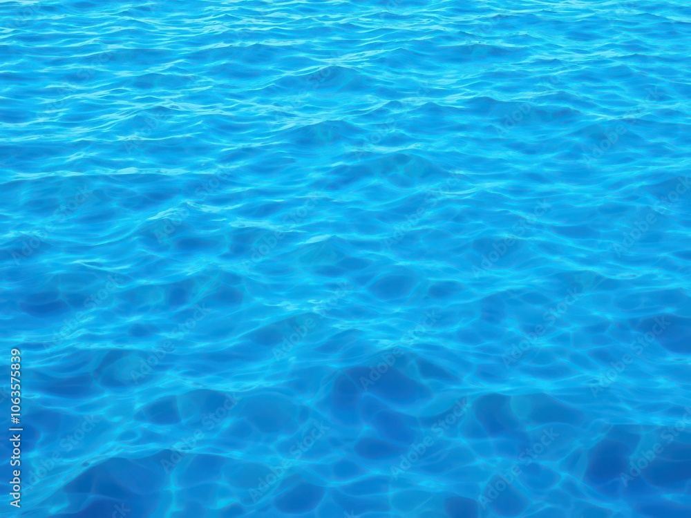 Blue water wave texture background with rippling pattern and vibrant shades of blue, aqua, tranquil