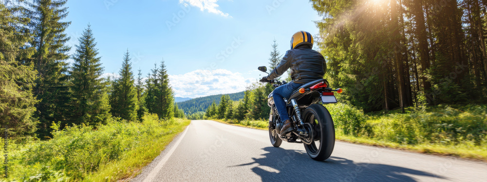 Obraz premium Motorcyclist riding a sports bike down a scenic country road
