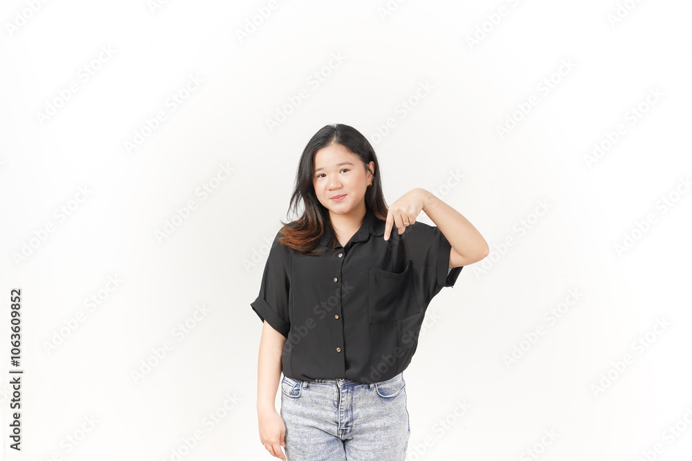 beautiful Asian woman smiles brightly while pointing downward, set against a clean white background beautiful Asian woman smiles brightly while pointing downward, set against a clean white background