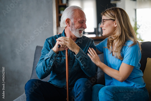 Elderly Man and Young Woman Sharing a Joyful Moment on Sofa photo