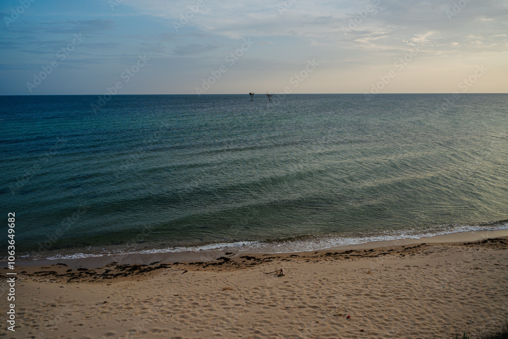 Natural background. Seascape. Clouds cover the sun. Sunset on the Black Sea coast. The road along the sea. Natural background. Seascape. Clouds cover the sun. Sunset on the Black Sea coast. The road along the sea.