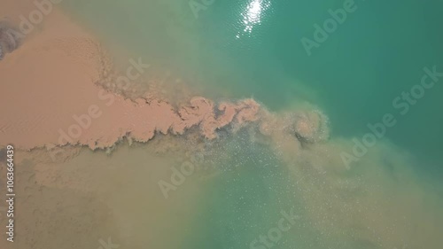 Industrial waste dropped in water and polluting the lake. Industry waste from aggregates pit waste and hazardous materials. Environmental issue around sustainability. Environment problem concept.