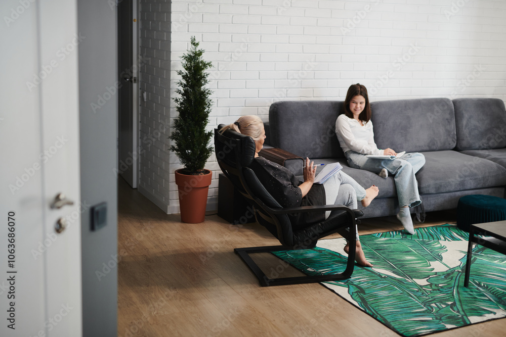 Schoolgirl girl at a psychological session with a child psychotherapist in a cozy office Schoolgirl girl at a psychological session with a child psychotherapist in a cozy office
