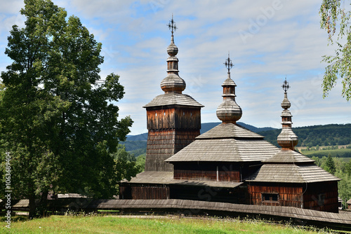 Historic wooden church with 3 metal crosses on the roof