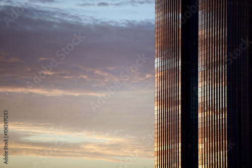 Glass surface of city skyscraper facades in the morning light. Commercial real estate. Modern business city district. Office buildings exterior closeup. Financial city district. Downtown.