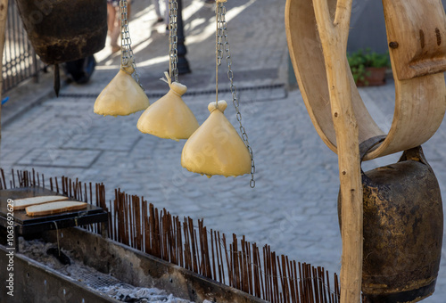 Gourmet cheese hung over a hot grill (caciocavallo impiccato), melted, cut, and spread on toasted bread photo