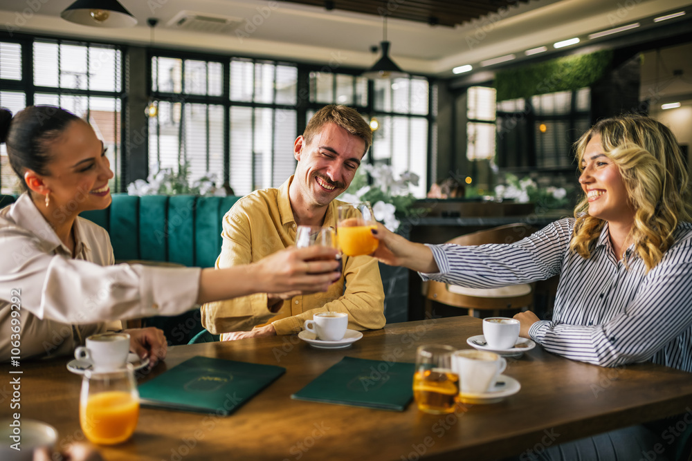 Group of friends toasting with drinks in a pub. Group of friends toasting with drinks in a pub.