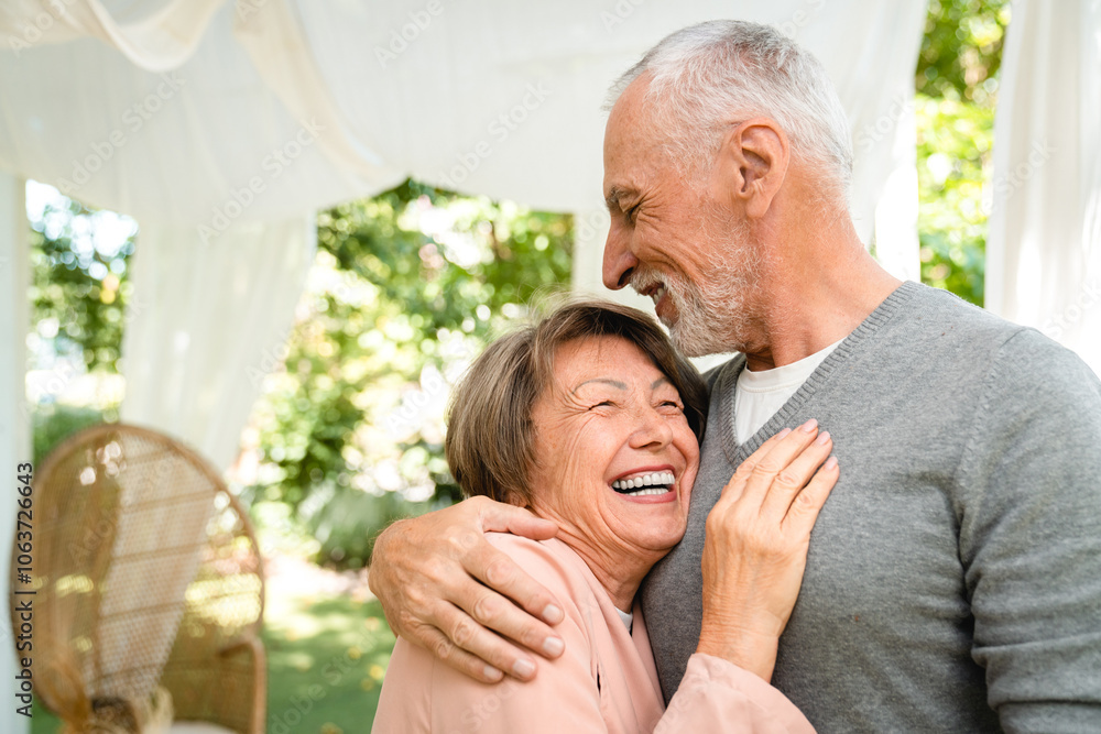 Fototapeta premium Active senior old elderly couple family spouses grandparents hugging embracing bonding
