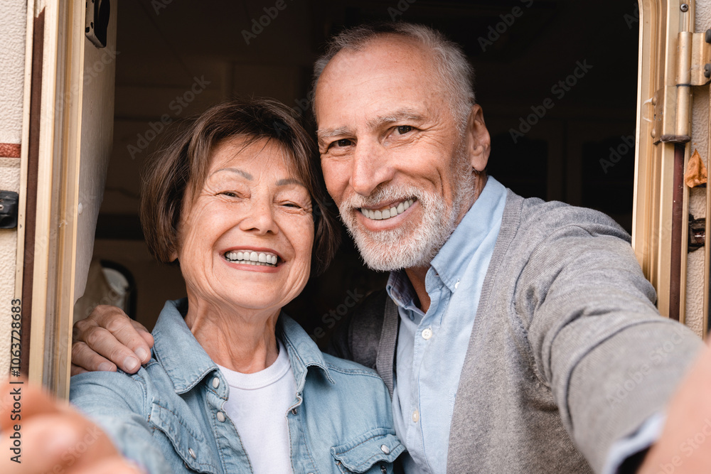 Elderly travel bloggers vlogging grandparents on videocall on social media while driving camper van Elderly travel bloggers vlogging grandparents on videocall on social media while driving camper van