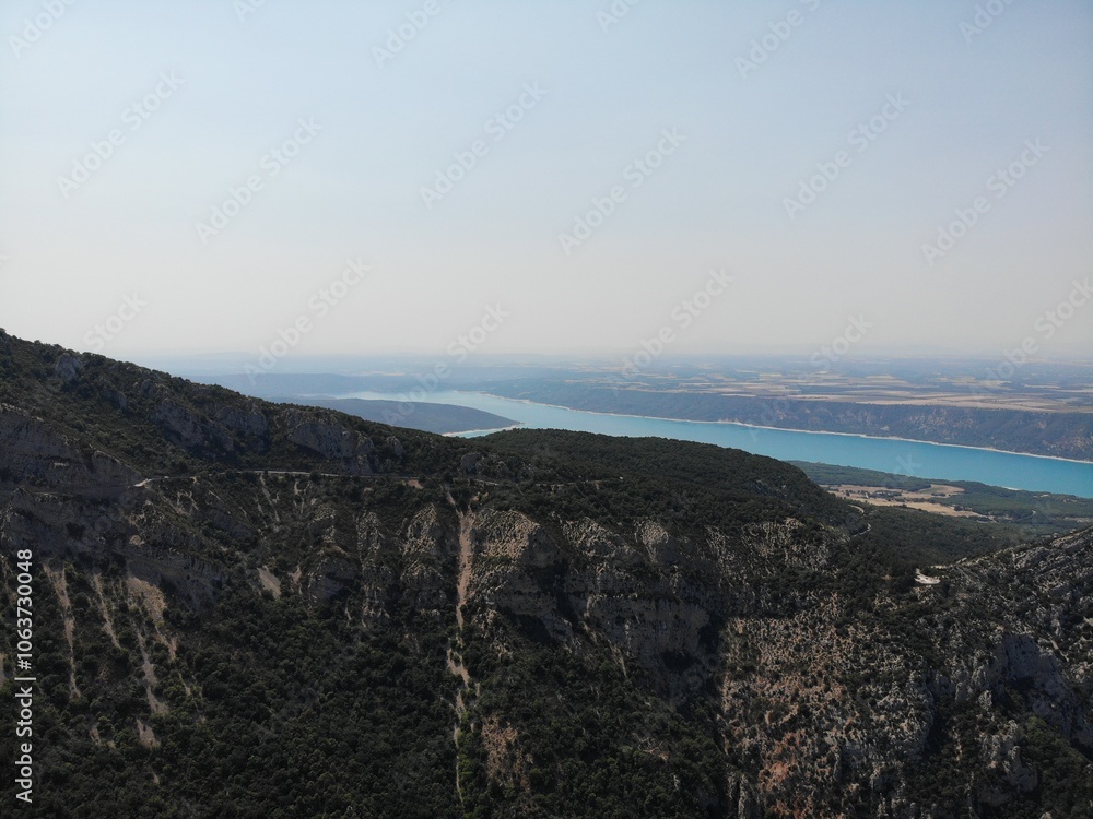 Fototapeta premium A photo of a view of a mountain with a lake and a body of water