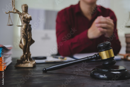 An Asian male lawyer meticulously reviews legal documents, ensuring accuracy and compliance for an upcoming court case. He highlights key points and prepares strategies to effectively