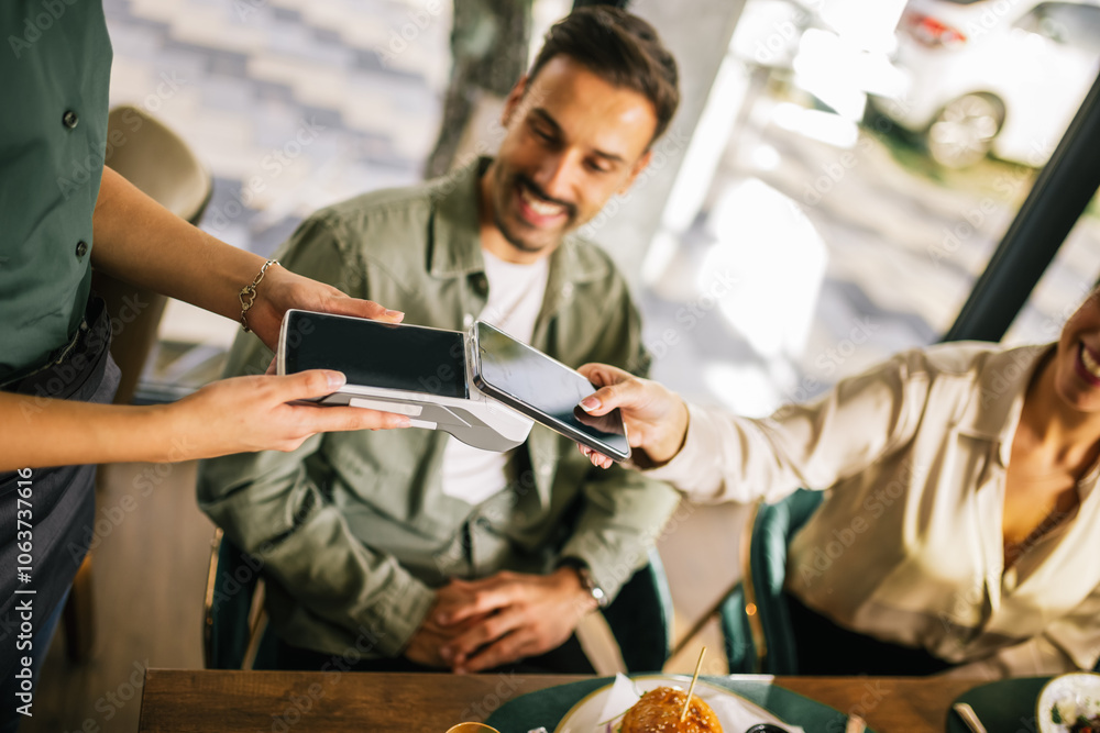 People paying with contactless credit card in a restaurant. People paying with contactless credit card in a restaurant.