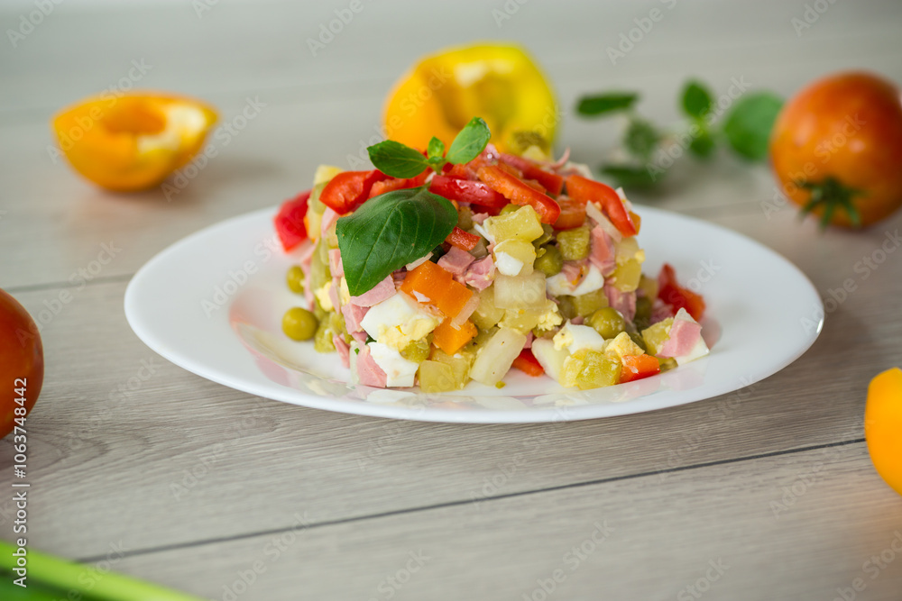 vegetable salad of boiled vegetables, with peas, sausage, sweet pepper. On a wooden table vegetable salad of boiled vegetables, with peas, sausage, sweet pepper. On a wooden table