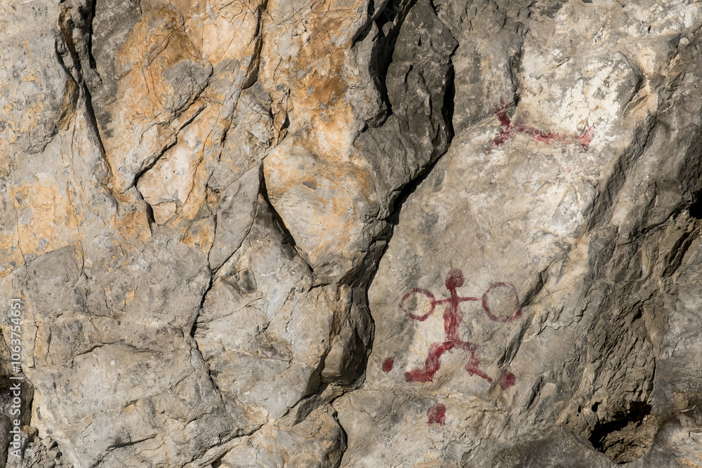 A rock with a red drawing of a man and a woman on it A rock with a red drawing of a man and a woman on it
