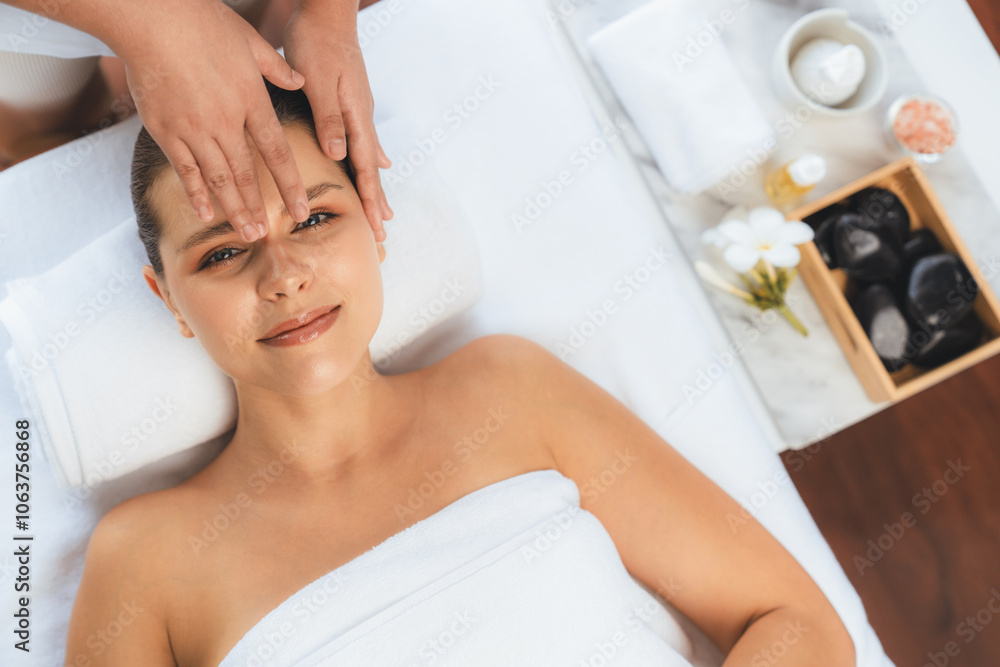 Obraz premium Panorama top view of woman enjoying relaxing anti-stress head massage and pampering facial beauty skin recreation leisure in dayspa modern light ambient at luxury resort or hotel spa salon. Quiescent