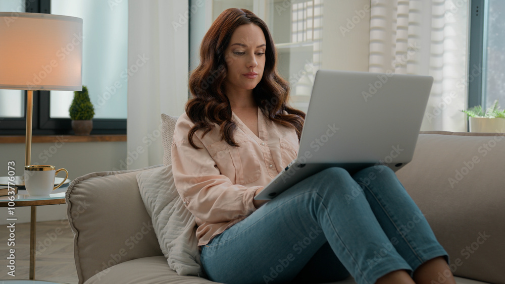 Caucasian young girl adult woman professional businesswoman female user on couch at home office at sofa using laptop typing computer message internet business working chatting browsing social media Caucasian young girl adult woman professional businesswoman female user on couch at home office at sofa using laptop typing computer message internet business working chatting browsing social media